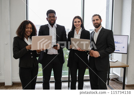 Diverse business team with laptops in modern office 115734138