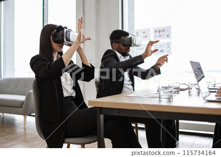 Business professionals using virtual reality technology in modern office 115734164