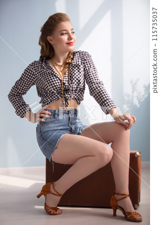 Retro pin-up girl with an old suitcase. Retro pin-up girl with an old suitcase. 115735037