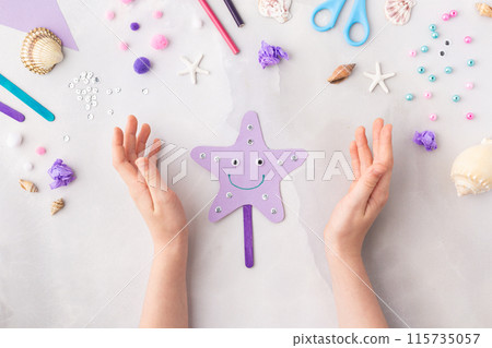 Violet paper sea star summer idea for kids craft in kindergarten hands ocean's day Violet paper sea star summer idea for kids craft in kindergarten hands ocean's day 115735057