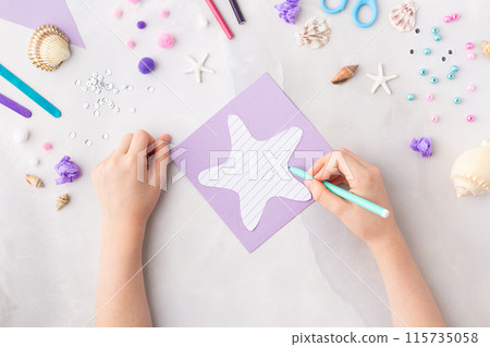 Violet paper sea star summer idea for kids craft in kindergarten hands ocean's day 115735058