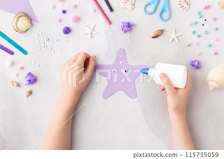 Violet paper sea star summer idea for kids craft in kindergarten hands ocean's day 115735059