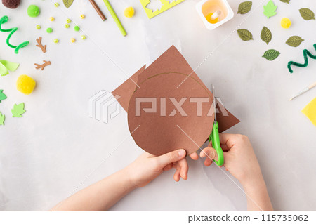 Paper tree with green leaves summer idea for kids craft in kindergarten hands Paper tree with green leaves summer idea for kids craft in kindergarten hands 115735062