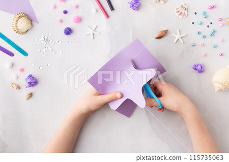 Violet paper sea star summer idea for kids craft in kindergarten hands ocean's day Violet paper sea star summer idea for kids craft in kindergarten hands ocean's day 115735063