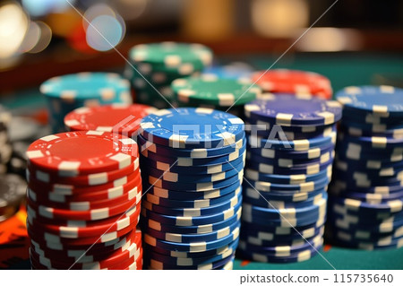 Close-up of poker chips in various colors, ideal for betting and gambling advertisements 115735640