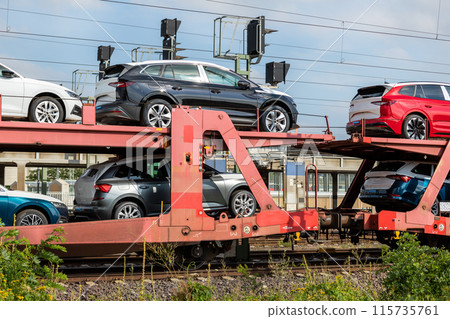 Mane new modern electric and fuel cars transportation by cargo freight train railway wagon. Railroad export and import automotive logistics service. Safety and insurance goods shipping insdustry Mane new modern electric and fuel cars transportation by cargo freight train railway wagon. Railroad export and import automotive logistics service. Safety and insurance goods shipping insdustry 115735761