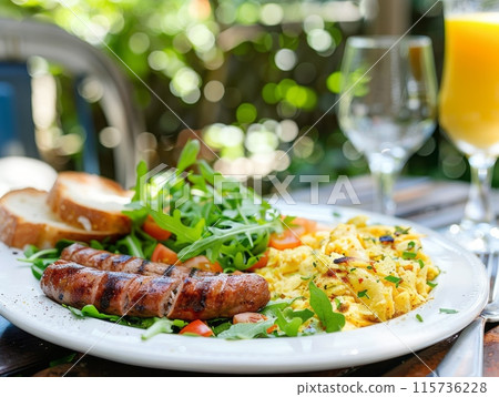 Close-up of a delicious brunch plate with sausage, scrambled eggs, and greens Close-up of a delicious brunch plate with sausage, scrambled eggs, and greens 115736228