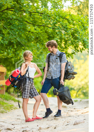 Hiking young couple with guitar backpack outdoor 115737450