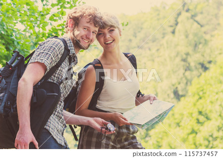 Hiking backpacking couple reading map on trip. 115737457