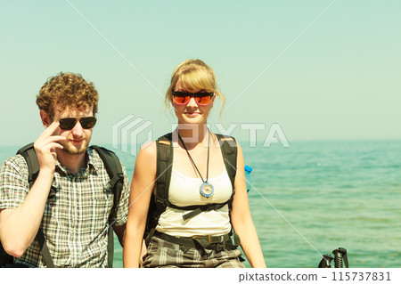 Two people tourists hiking by sea ocean. Two people tourists hiking by sea ocean. 115737831