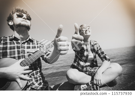 Young man hipster with guitar and woman. Young man hipster with guitar and woman. 115737930