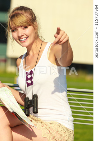 Woman in city read map pointing 115737964