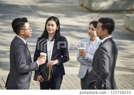 group of asian business people standing chatting on street 115738233