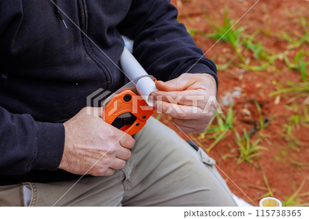 Water pipes are cut using special scissors by plumbers when they are installed Water pipes are cut using special scissors by plumbers when they are installed 115738365