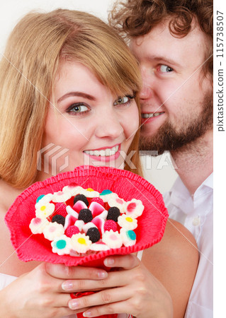 Man whispering to woman ear sharing secret. 115738507