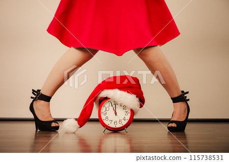 Woman in high heels with alarm clock. Christmas. 115738531