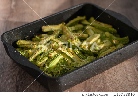 zucchini baked in the oven on a wooden table 115738810