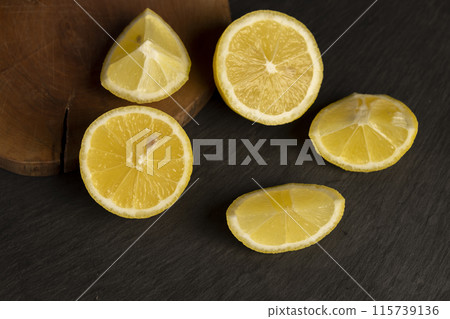 close-up of a table with slices of yellow lemon close-up of a table with slices of yellow lemon 115739136