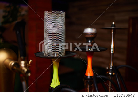 Person holding a hookah at a drinking establishment event Person holding a hookah at a drinking establishment event 115739648