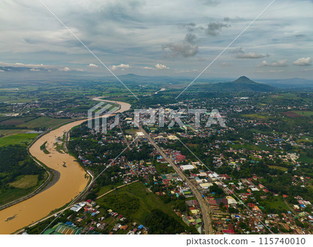 Drone view of Valencia City with river in mountain province. Mindanao, Philippines. Drone view of Valencia City with river in mountain province. Mindanao, Philippines. 115740010