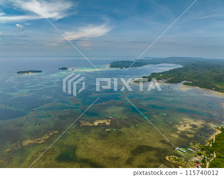 Blue sea with fish cages and farms. Blue sky and clouds. Mindanao, Philippines. Blue sea with fish cages and farms. Blue sky and clouds. Mindanao, Philippines. 115740012