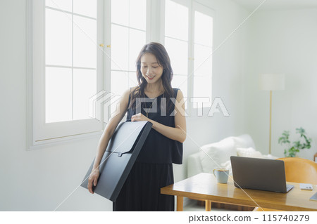 Young woman with art portfolio bag Young woman with art portfolio bag 115740279