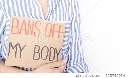 Woman holding Bans Off My Body sign at reproductive rights rally in city center during sunny day 115740954