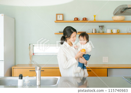 Parent and child standing in the kitchen Parent and child standing in the kitchen 115740983