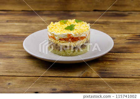 Traditional russian salad Mimosa on wooden table Traditional russian salad Mimosa on wooden table 115741002