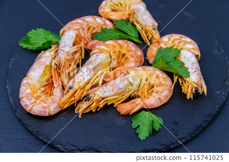 Boiled large langoustines on a black slate 115741025