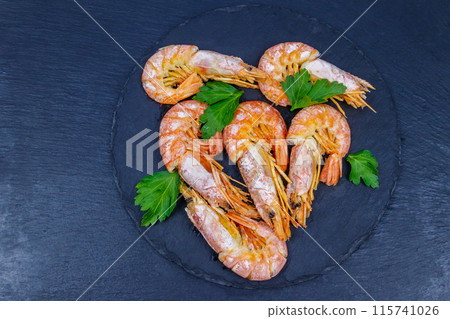 Boiled large langoustines on a black slate. Top view Boiled large langoustines on a black slate. Top view 115741026