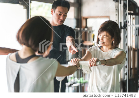 A personal trainer and a female member using a body fat scale at a gym (diet, weight loss, body makeover) A personal trainer and a female member using a body fat scale at a gym (diet, weight loss, body makeover) 115741498