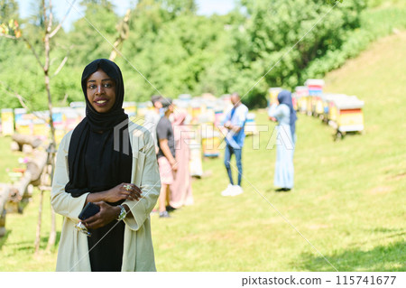 Empowered Middle Eastern Muslim Woman in Hijab Balances Modern Technology and Traditional Beekeeping Business 115741677