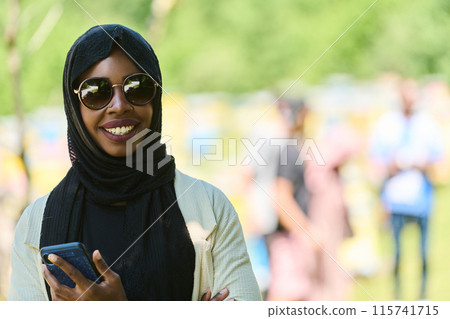 Empowered Middle Eastern Muslim Woman in Hijab Balances Modern Technology and Traditional Beekeeping Business 115741715