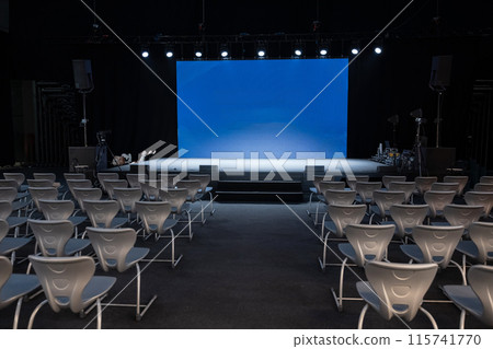 empty conference stage and a blank blue screen empty conference stage and a blank blue screen 115741770