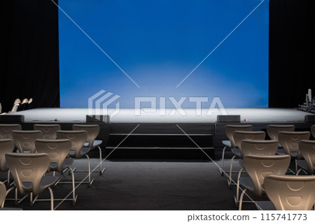 empty conference stage and a blank blue screen empty conference stage and a blank blue screen 115741773