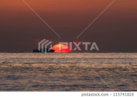 Daruma: A tourist boat sailing with the sunset in the background 115741820