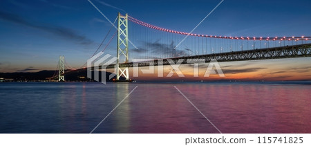 A panoramic view of the illuminated Akashi Kaikyo Bridge and the red-tinted water A panoramic view of the illuminated Akashi Kaikyo Bridge and the red-tinted water 115741825