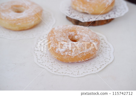 donuts with powdered sugar on top as a background donuts with powdered sugar on top as a background 115742712
