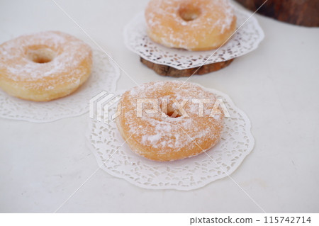 donuts with powdered sugar on top as a background 115742714