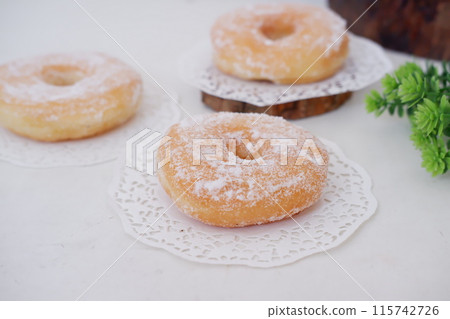 donuts with powdered sugar on top as a background 115742726