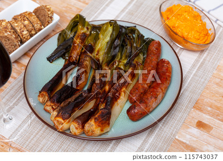 Sausages and calcot with romesco sauce, typical Catalan dish Calsot con butifarra Sausages and calcot with romesco sauce, typical Catalan dish Calsot con butifarra 115743037