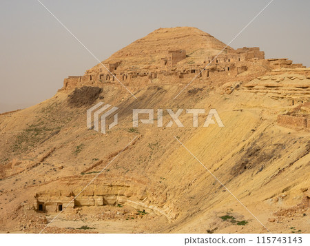 Ksar Guermessa located under the peak of Ras Oum Moutmana, Tunisia Ksar Guermessa located under the peak of Ras Oum Moutmana, Tunisia 115743143