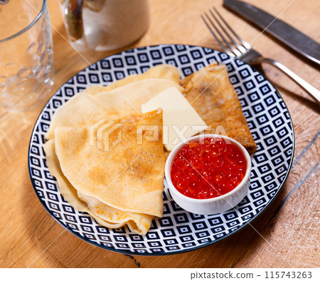 On plate - ruddy soft pancakes with butter and fresh-grain caviar On plate - ruddy soft pancakes with butter and fresh-grain caviar 115743263