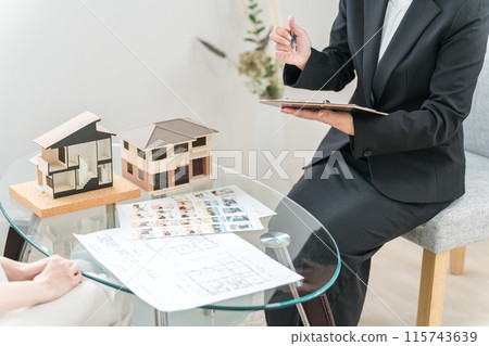 一位亞洲女性向一位女商人提供諮詢，女商人解釋並出售她的房屋、房地產、裝修和資產管理。 115743639