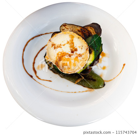 Delicious eggplant grilled with vegetables and goat cheese served on plate 115743704