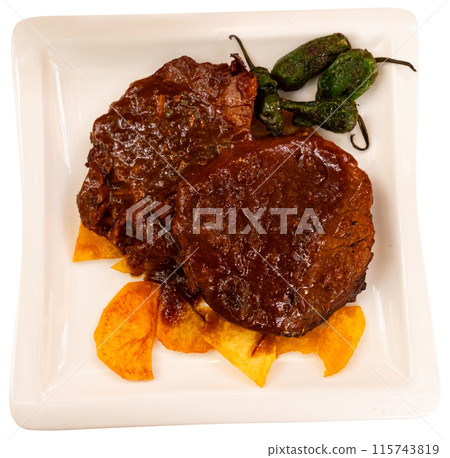 Tasty baked beef steak in fragrant gravy served with potatoes at plate. Traditional Spanish dish Tasty baked beef steak in fragrant gravy served with potatoes at plate. Traditional Spanish dish 115743819