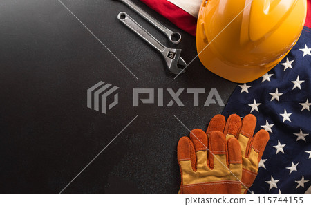 Happy Labor day concept. American flag with different construction tools on dark background. 115744155
