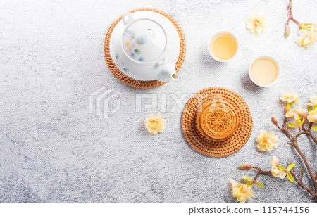 Chinese Mid-Autumn Festival concept made from mooncakes, tea and plum blossom on stone background. 115744156