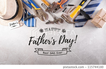 Happy Father's Day decoration with beautiful tie with mustache, hand tools, glasses, gift box and hat on dark stone background. 115744180